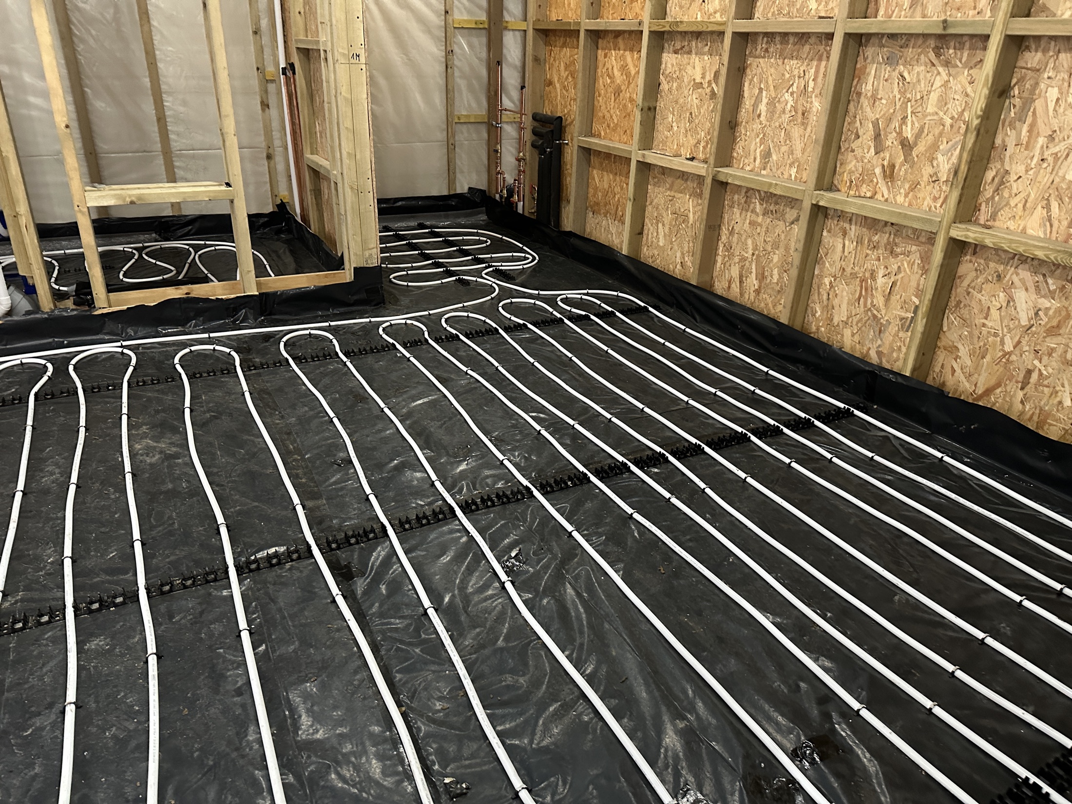 Wet underfloor heating pipe loops installed at a Hampstead project before floor closure