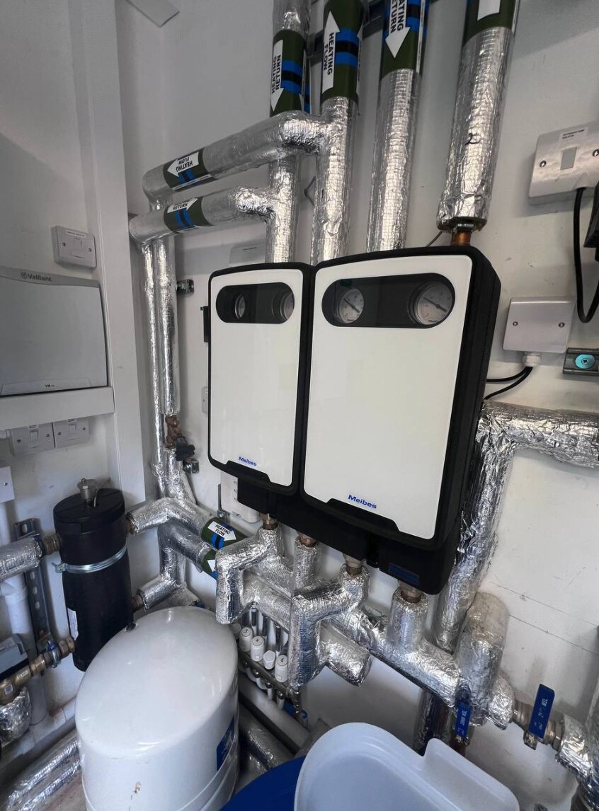 New Forest plant room with insulated distribution pipework, pump groups and expansion vessel